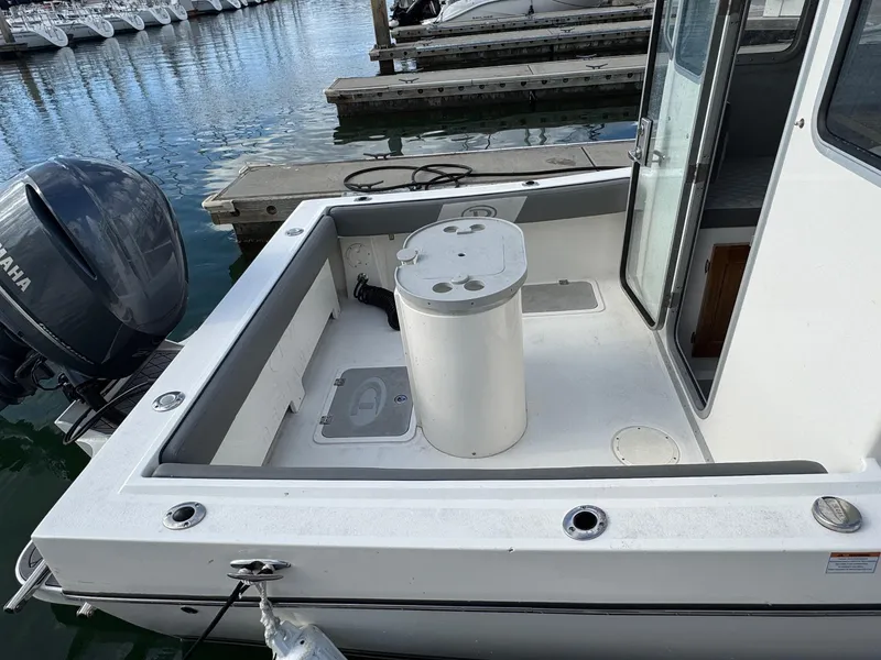 Slide: The Image of 2024 Defiance San Juan 220 boat with Yamaha engine, docked at marina. - 9