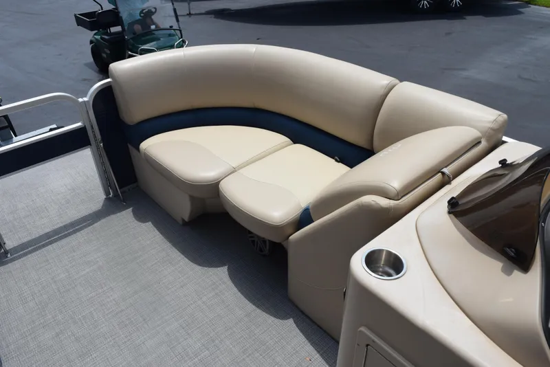 Slide: The Image of 2017 Manitou Aurora LE 21 RF SHP pontoon boat with beige seating and cup holder. - 12