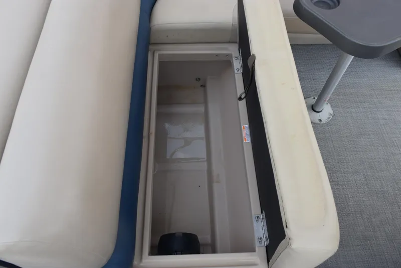 Slide: The Image of 2017 Manitou Aurora LE 21 RF SHP boat storage compartment with open seat lid. - 17
