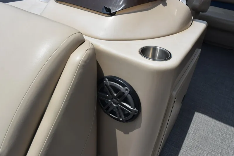 Slide: The Image of 2017 Manitou Aurora LE 21 RF SHP boat interior with speaker and cup holder. - 19