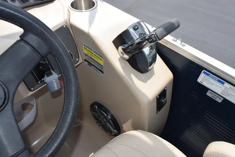 Slide: The Image of 2017 Manitou Aurora LE 21 RF SHP boat steering console with throttle and controls. - 21