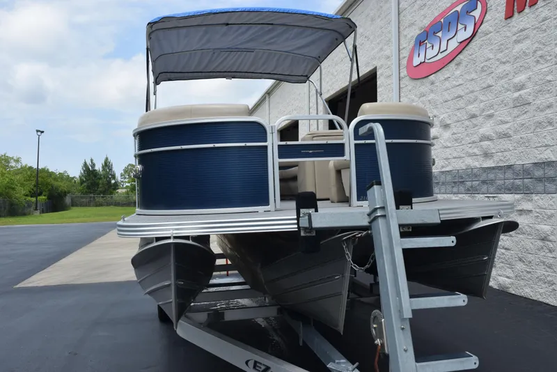 Slide: The Image of 2017 Manitou Aurora LE 21 RF SHP pontoon boat on trailer, parked outside dealership. - 3