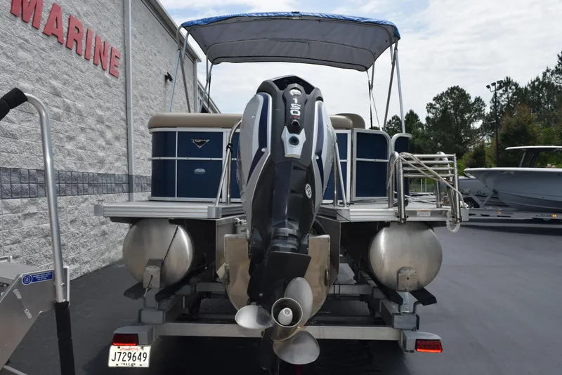 Slide: The Image of 2017 Manitou Aurora LE 21 RF SHP pontoon boat with outboard motor, parked outdoors. - 5