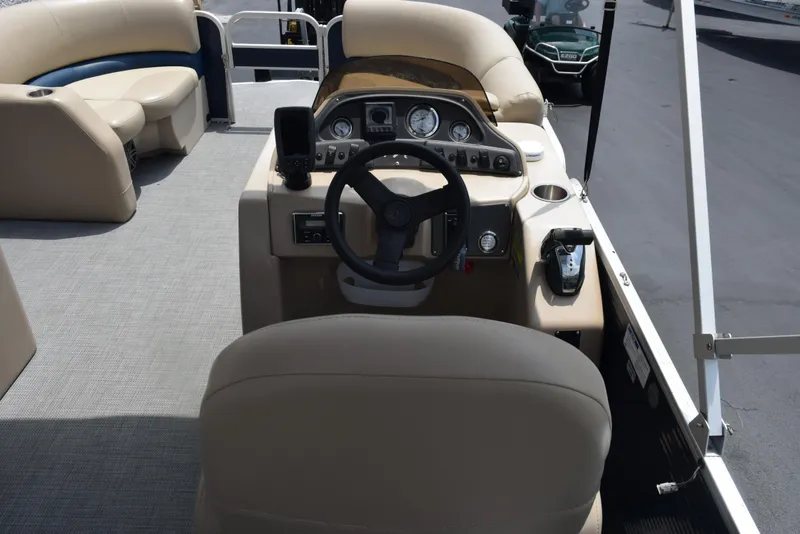 Slide: The Image of 2017 Manitou Aurora LE 21 RF SHP boat interior with steering console and seating. - 9