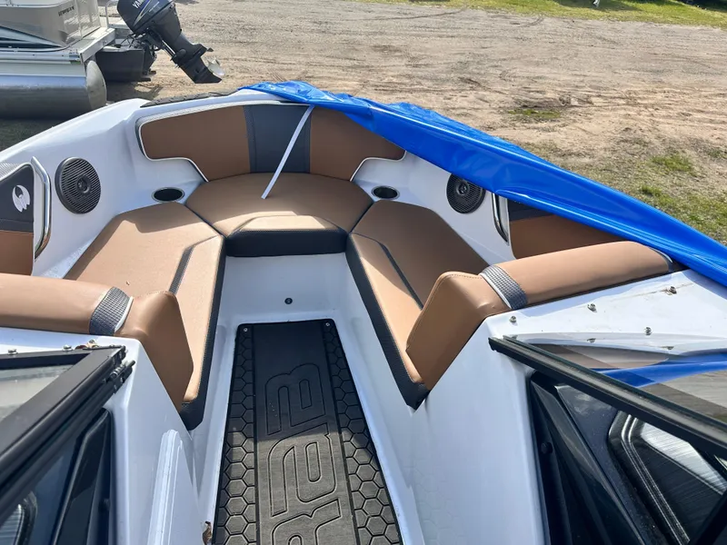 Slide: The Image of 2021 Scarab 195 Jet Boat interior with tan seating and blue cover. - 4