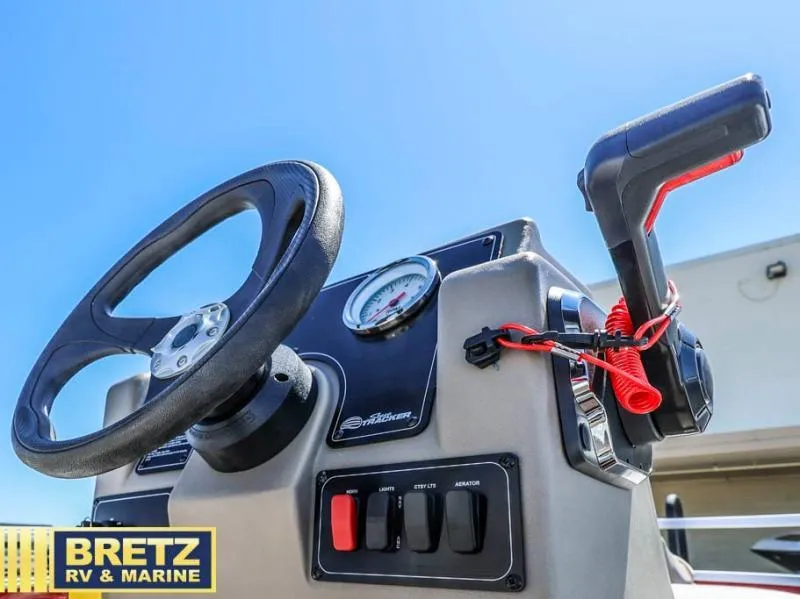 Slide: The Image of 2025 BASS BUGGY 16 XL Select boat console with steering wheel and controls. - 10