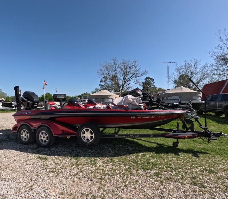 Slide: The Image of 2007 Ranger Z21 Comanche boat on trailer, parked outdoors under clear blue sky. - 1