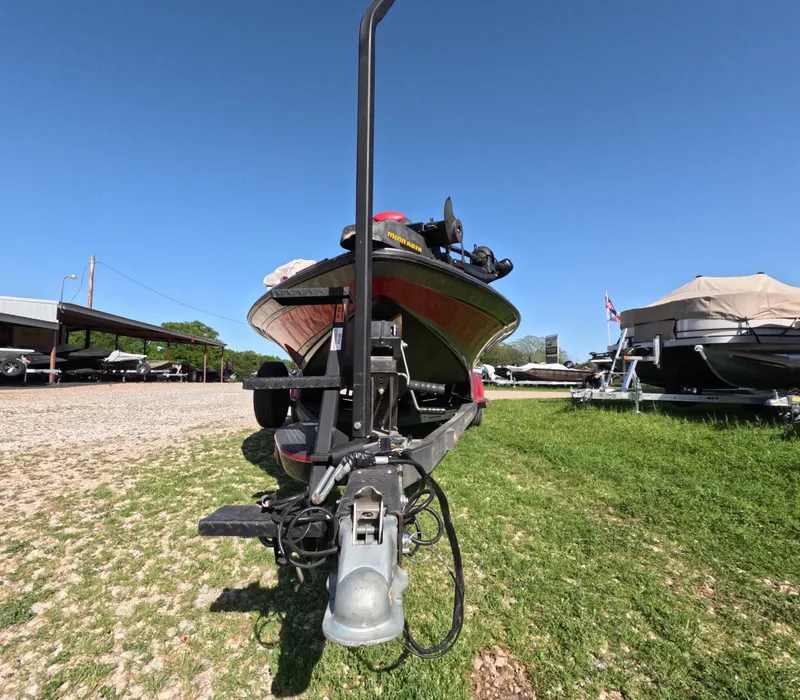 Slide: The Image of 2007 Ranger Z21 Comanche boat on trailer, parked on grass under clear blue sky. - 2