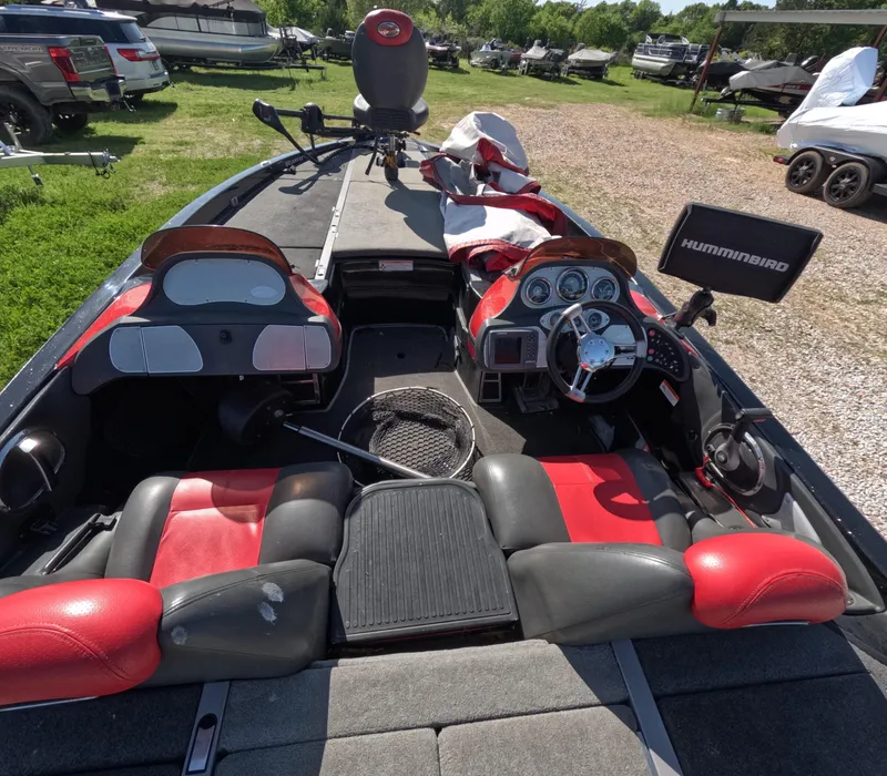 Slide: The Image of 2007 Ranger Z21 Comanche boat interior with red seats and fishing equipment. - 3