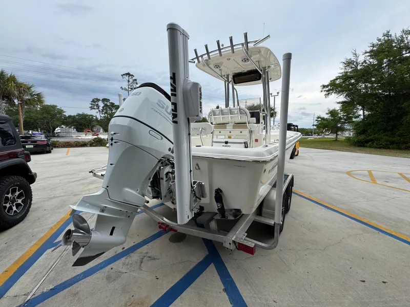 Slide: The Image of 2024 Bulls Bay 2400 boat on trailer, rear view, parked in a lot. - 13