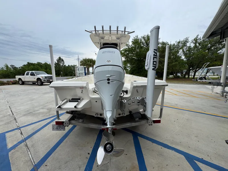Slide: The Image of 2024 Bulls Bay 2400 boat, rear view, parked on a trailer in a lot. - 15