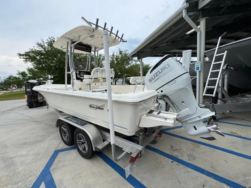 Slide: The Image of 2024 Bulls Bay 2400 boat with Suzuki outboard motor on a trailer. - 17
