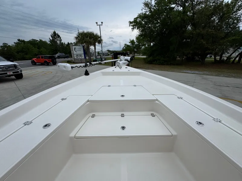 Slide: The Image of 2024 Bulls Bay 2400 boat deck, spacious layout, parked outdoors. - 20