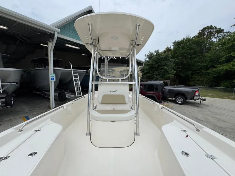 Slide: The Image of 2024 Bulls Bay 2400 boat with T-top, parked near a garage. - 23