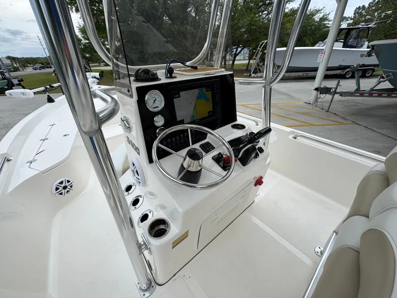 Slide: The Image of 2024 Bulls Bay 2400 boat console with steering wheel and navigation display. - 29