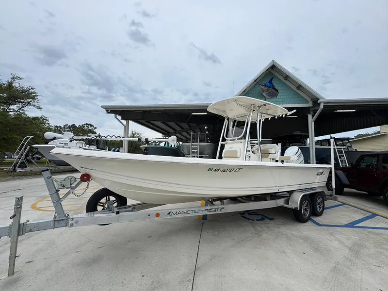 Slide: The Image of 2024 Bulls Bay 2400 boat on trailer at marina under cloudy sky. - 3