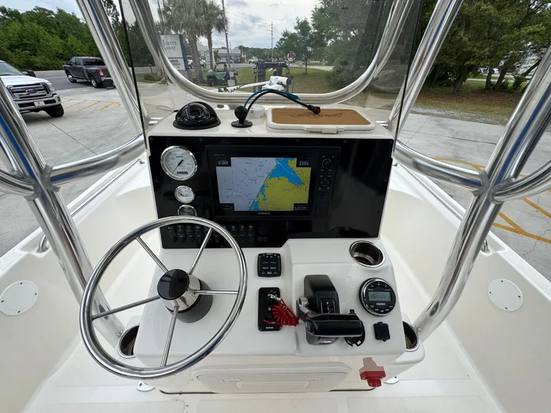 Slide: The Image of 2024 Bulls Bay 2400 boat dashboard with navigation system and steering wheel. - 30