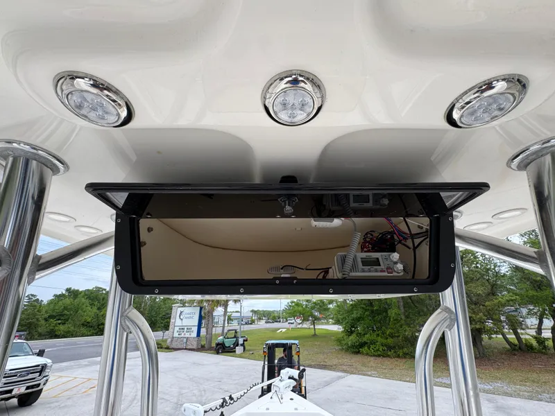 Slide: The Image of 2024 Bulls Bay 2400 boat console with overhead lights and storage compartment. - 32