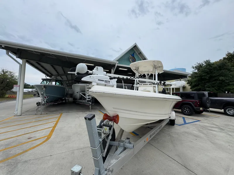 Slide: The Image of 2024 Bulls Bay 2400 boat on trailer at dealership, under cloudy sky. - 6