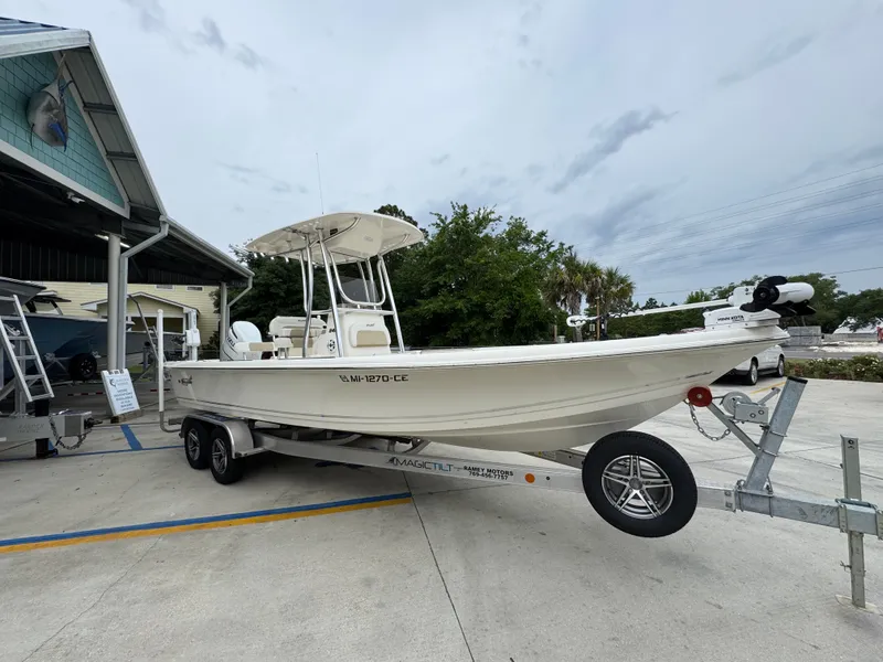 Slide: The Image of 2024 Bulls Bay 2400 boat on trailer, parked outdoors near a building. - 8