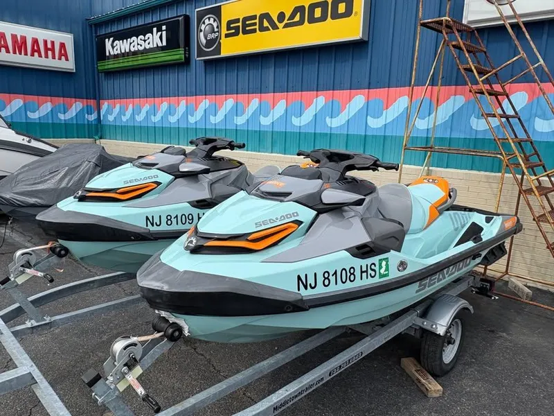 Slide: The Image of Two 2022 Sea-Doo Wake Pro 230 jet skis on trailers outside a dealership. - 5
