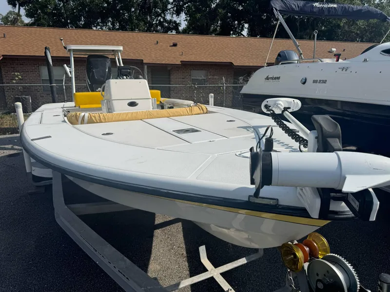 Slide: The Image of 2002 Ranger 191 Cayman boat on trailer, white with yellow accents, parked outdoors. - 5