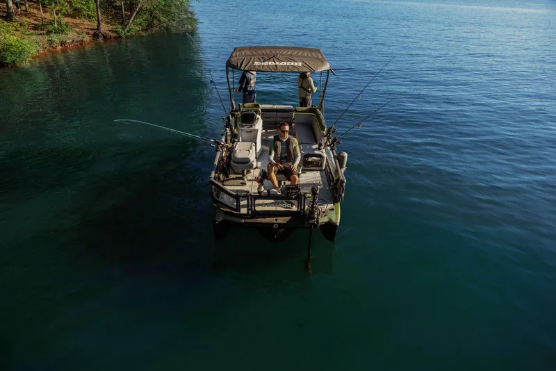 Slide: The Image of 2025 Sea-Doo Switch™ Fish 21 on serene lake, ideal for fishing adventures. - 10