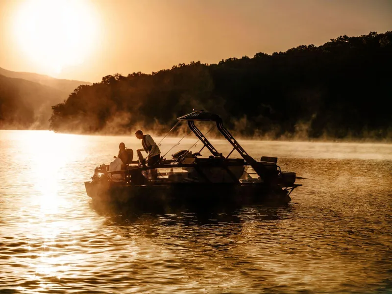Slide: The Image of 2025 Sea-Doo Switch™ Fish 21 on serene lake at sunset, perfect for fishing adventures. - 8