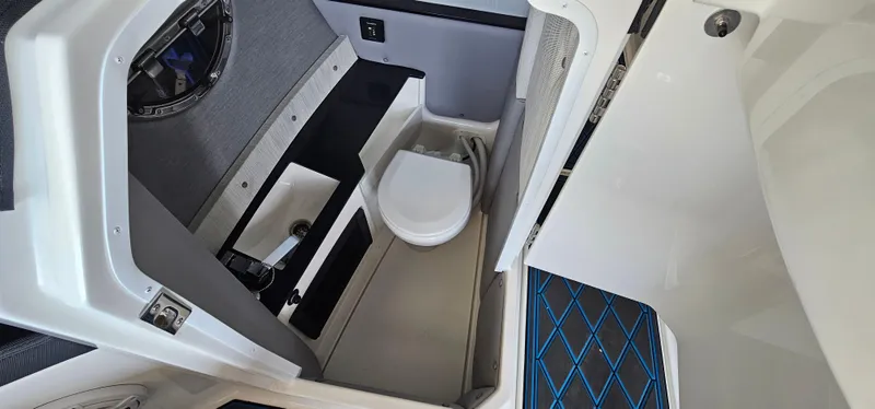 Slide: The Image of 2022 Cobalt R6 boat interior with compact bathroom and modern amenities. - 12