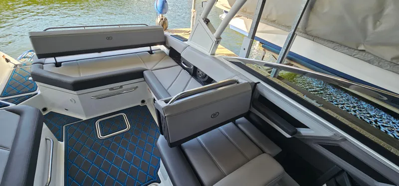 Slide: The Image of 2022 Cobalt R6 boat interior with sleek seating and modern design on the water. - 15