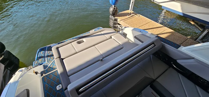 Slide: The Image of 2022 Cobalt R6 boat with sleek seating, docked by the water. - 16