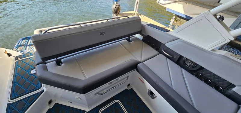 Slide: The Image of 2022 Cobalt R6 boat interior with gray seating, docked by the water. - 19