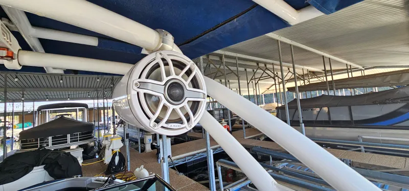 Slide: The Image of 2022 Cobalt R6 boat with mounted speaker in marina setting. - 21