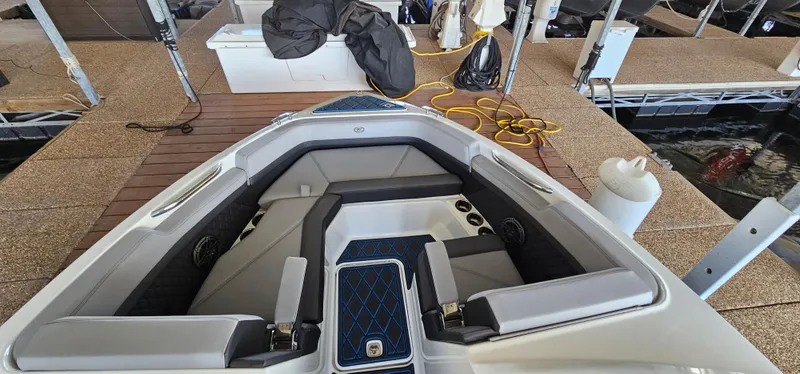 Slide: The Image of 2022 Cobalt R6 boat interior with sleek seating at a dock. - 22