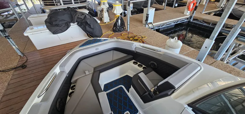 Slide: The Image of 2022 Cobalt R6 boat interior at marina, featuring sleek seating and modern design. - 23