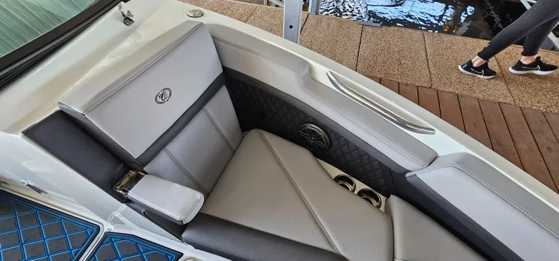 Slide: The Image of 2022 Cobalt R6 boat interior with luxurious gray seating and cup holders. - 25