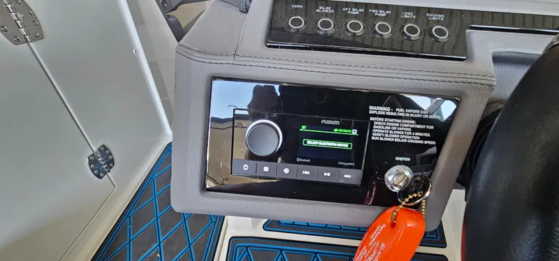 Slide: The Image of Control panel of a 2022 Cobalt R6 boat with audio system and key fob. - 30