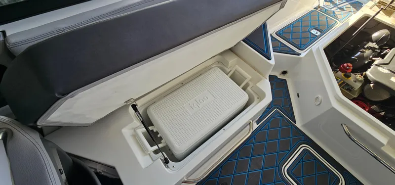 Slide: The Image of 2022 Cobalt R6 boat interior with open storage compartment and cooler. - 31
