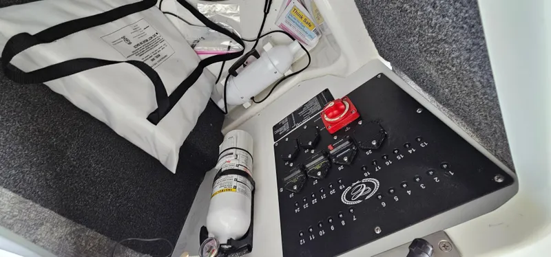 Slide: The Image of 2022 Cobalt R6 boat interior with control panel and safety equipment. - 32