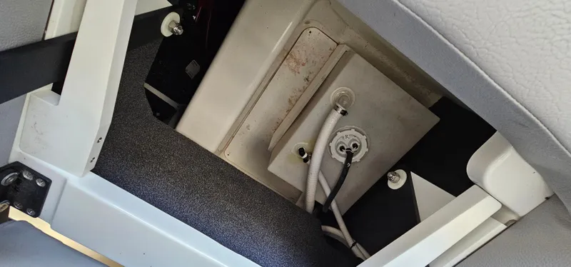 Slide: The Image of 2022 Cobalt R6 boat interior compartment with wiring and storage space. - 33