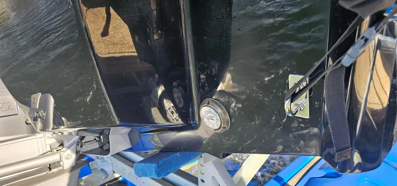 Slide: The Image of 2022 Cobalt R6 boat hull on a trailer, reflecting sunlight over water. - 39