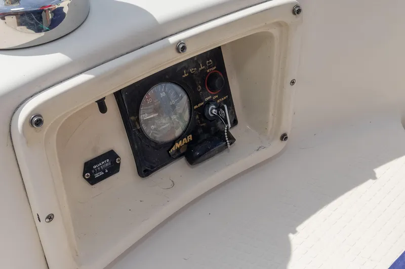 Slide: The Image of Control panel of a 2011 Hake Seaward 32 RK boat, featuring gauges and ignition. - 19