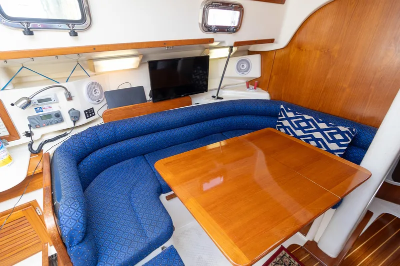 Slide: The Image of Cozy 2011 Hake Seaward 32 RK yacht interior with blue seating and wooden table. - 27