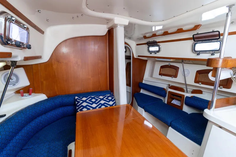 Slide: The Image of Interior of 2011 Hake Seaward 32 RK sailboat with blue seating and wooden accents. - 29