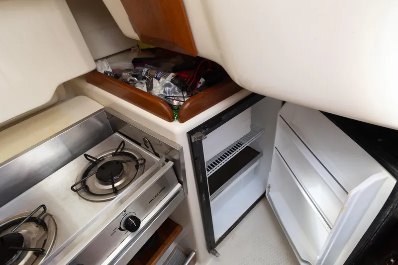 Slide: The Image of Compact kitchen area in a 2011 Hake Seaward 32 RK sailboat with stove and fridge. - 42
