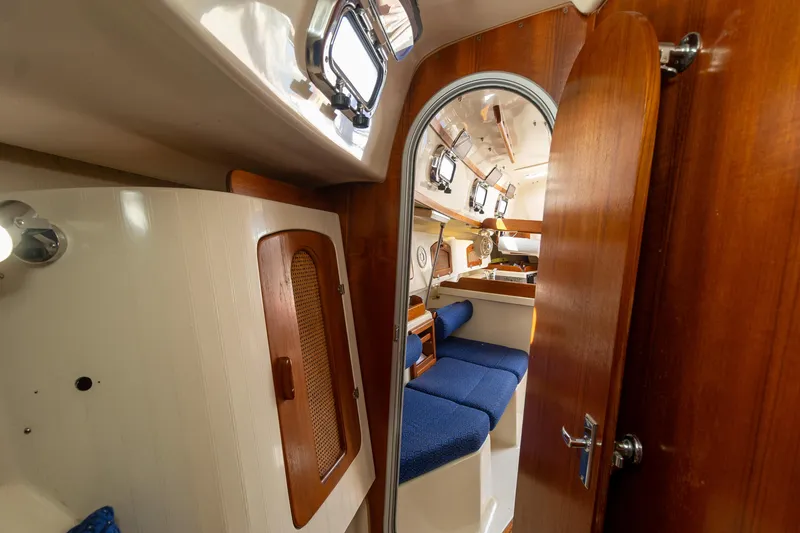 Slide: The Image of Interior of 2011 Hake Seaward 32 RK sailboat with wooden finishes and blue seating. - 45
