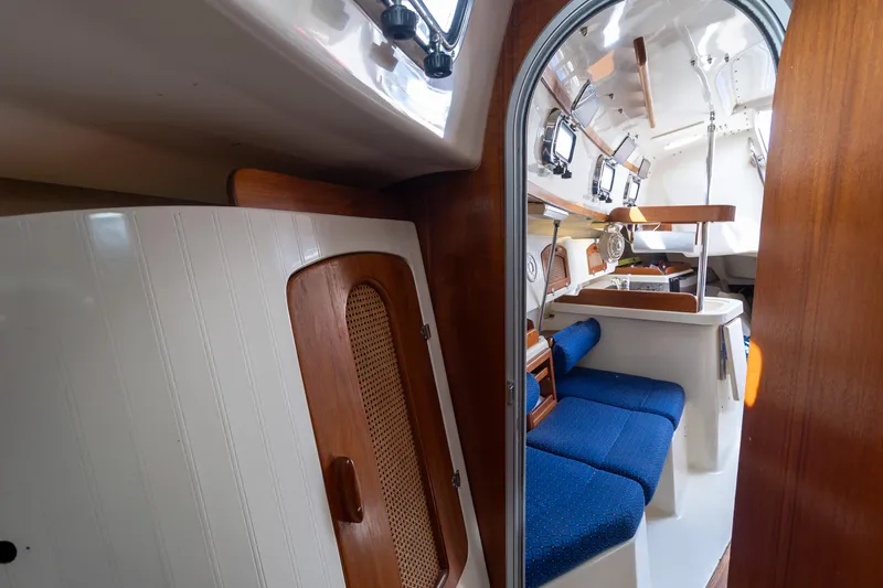 Slide: The Image of Interior of 2011 Hake Seaward 32 RK sailboat with blue seating and wooden accents. - 46
