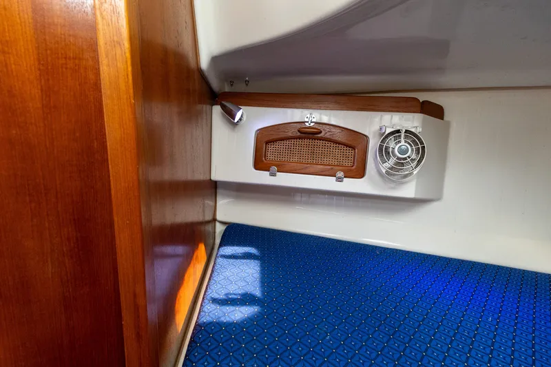 Slide: The Image of Interior cabin of 2011 Hake Seaward 32 RK sailboat with wooden accents and blue upholstery. - 48