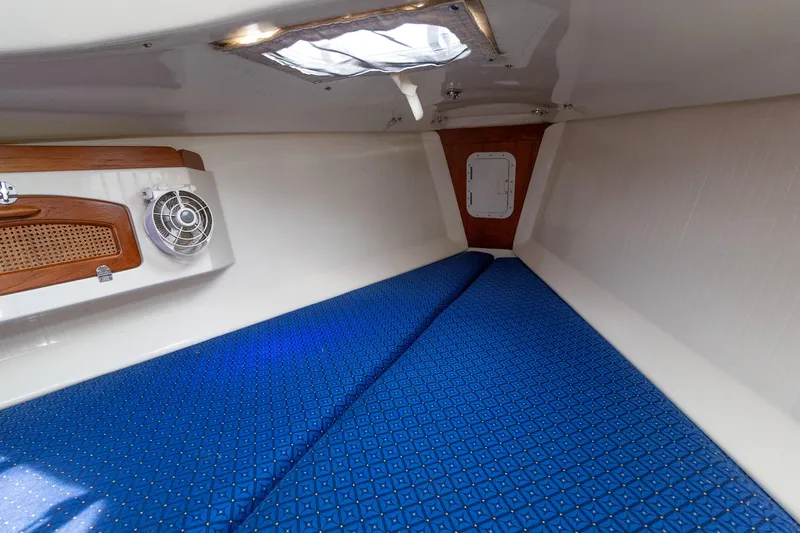 Slide: The Image of 2011 Hake Seaward 32 RK cabin interior with blue bedding and wooden accents. - 49