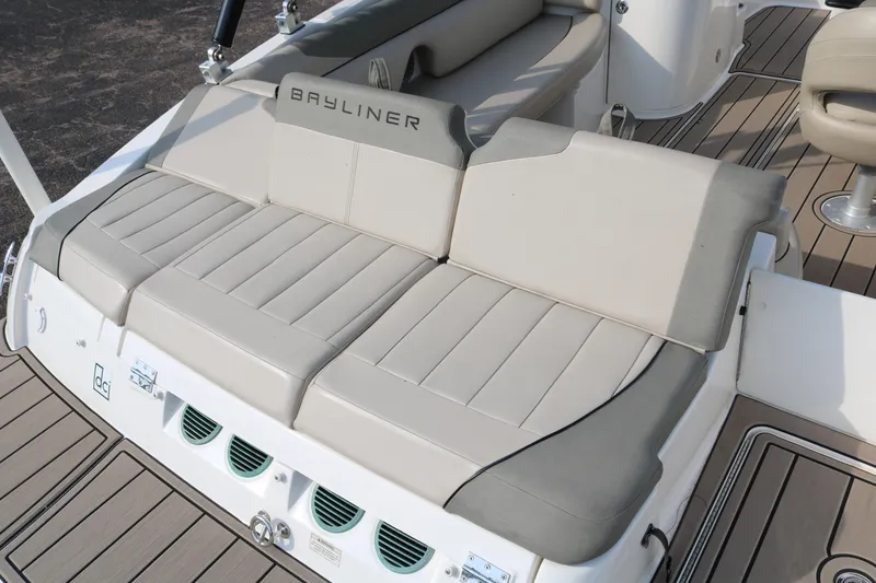 Slide: The Image of 2016 Bayliner 215 Deck Boat with beige seating and sleek design. - 10